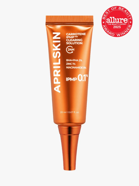APRILSKIN Carrotene IPMP Clearing Solution in branded metallic orange tube with cap on light gray background with red Allure Best of Beauty seal in the top right corner